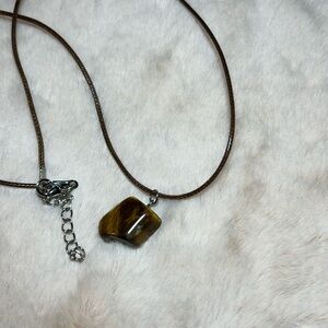 Healing Gem Stone with waxed-cotton brown rope 20” chain. Stone is brownish.